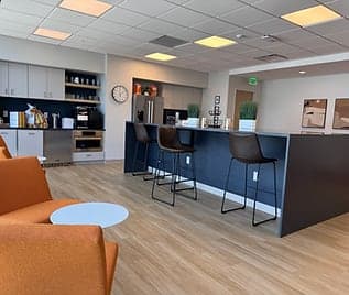 The members' kitchen and lounge, with a breakfast bar and soft seating