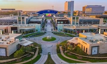 Aerial view of The Star District in Frisco, Texas, looking down the central plaza toward the Ford Center